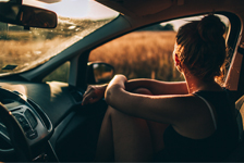 Girl looking out window of car