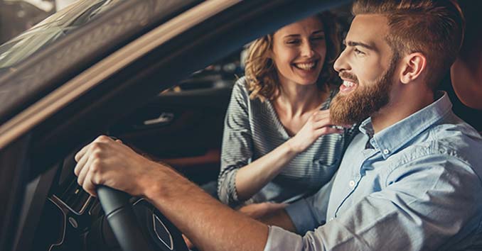 car Couple behind the Wheel in a Car