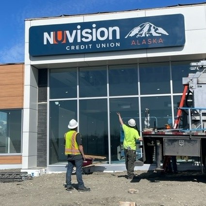 Wasilla branch exterior with two construction workers wearing yellow.